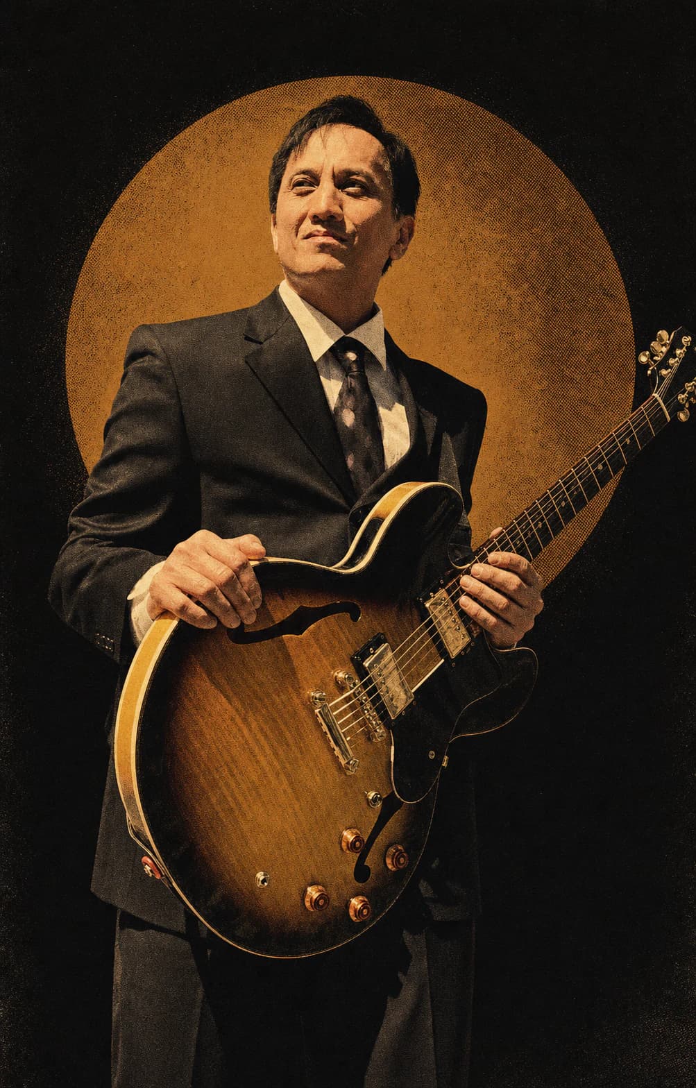 Gary Dacanay holding a sunburst hollow-body guitar